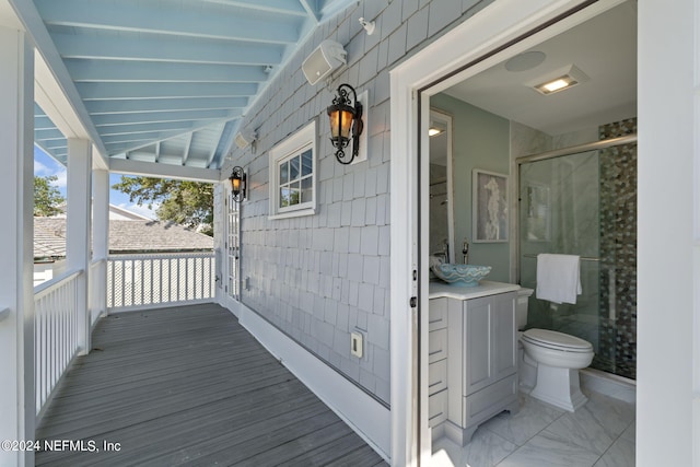 wooden terrace with sink and a porch