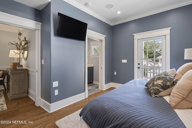 bedroom with wood-type flooring, crown molding, ensuite bath, and access to exterior