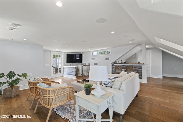 living room with wood-type flooring and lofted ceiling