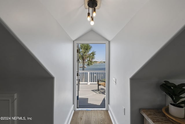 hall featuring lofted ceiling and light wood-type flooring