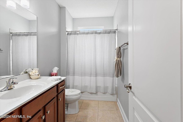 full bathroom featuring tile patterned flooring, shower / bathtub combination with curtain, toilet, vanity, and a textured ceiling