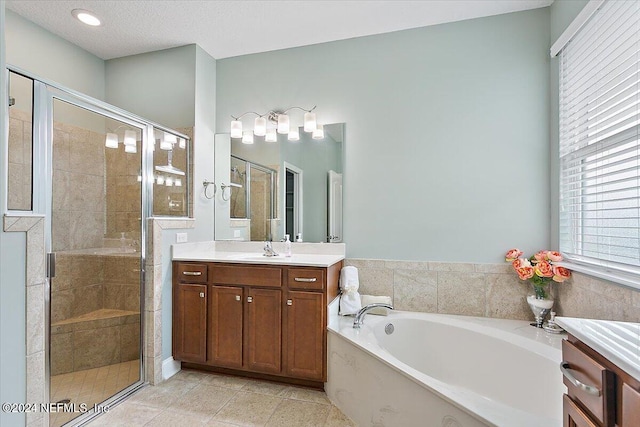 bathroom with vanity, a textured ceiling, independent shower and bath, and tile patterned flooring