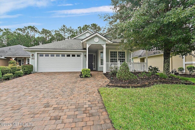 ranch-style home with a garage and a front yard