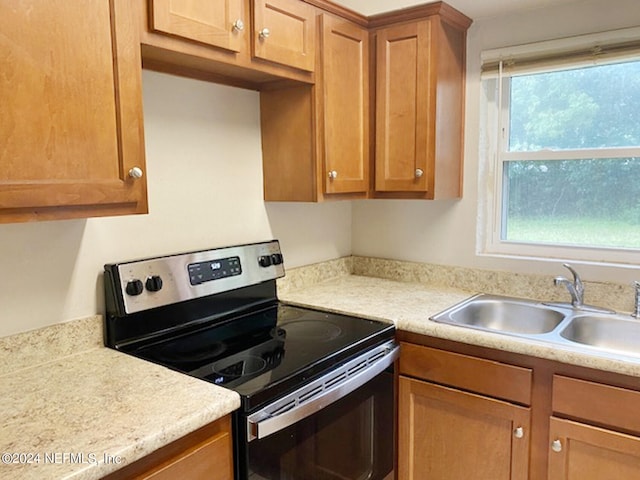 kitchen featuring stainless steel range with electric cooktop and sink