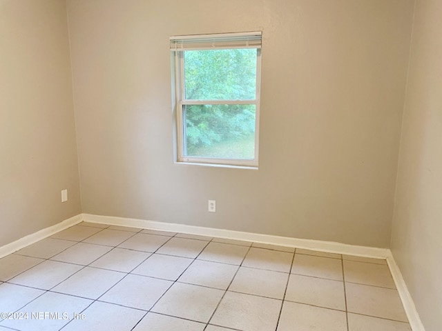 spare room featuring light tile patterned floors