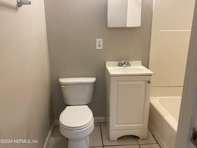 bathroom featuring vanity, a bathtub, toilet, and tile patterned floors