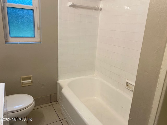 bathroom with toilet, bathtub / shower combination, and tile patterned floors