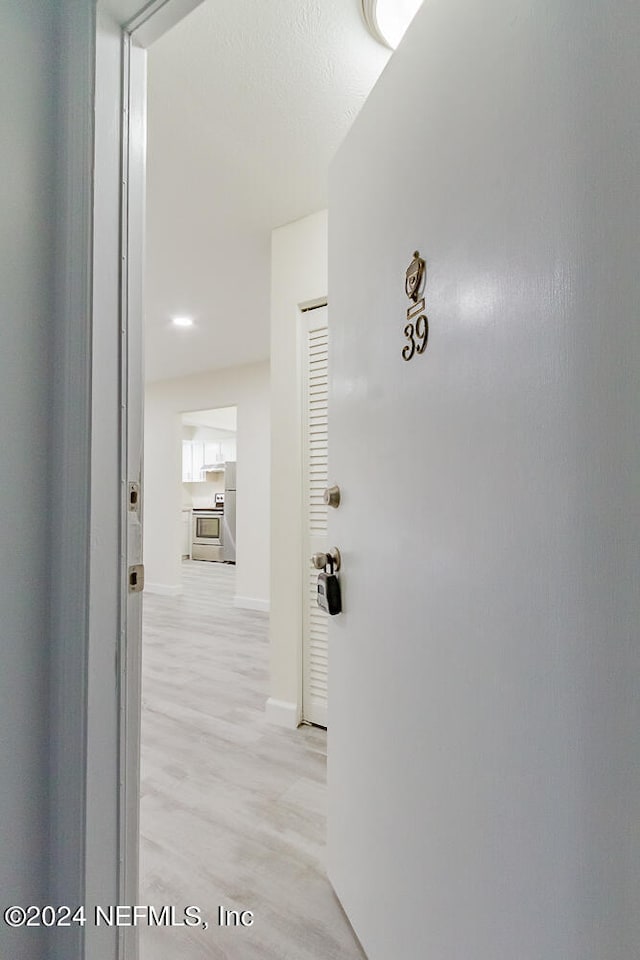 hallway with light wood-type flooring