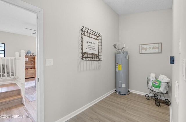 interior space with light hardwood / wood-style floors and water heater