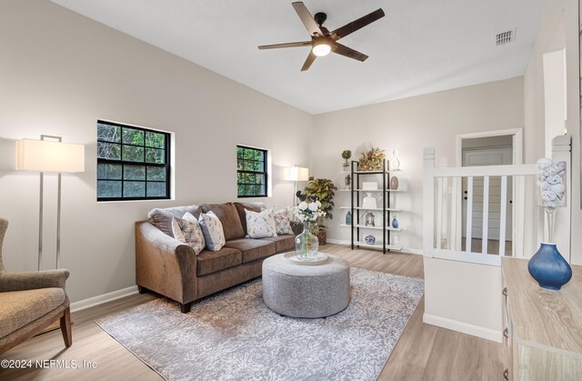 living room with ceiling fan and hardwood / wood-style flooring