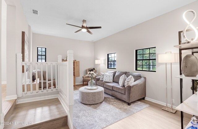 living room with ceiling fan and light hardwood / wood-style flooring