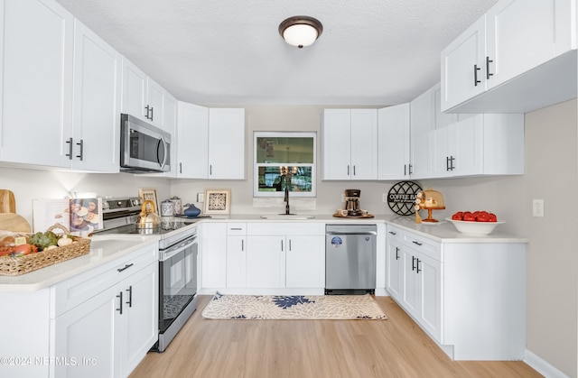 kitchen with stainless steel appliances and white cabinets