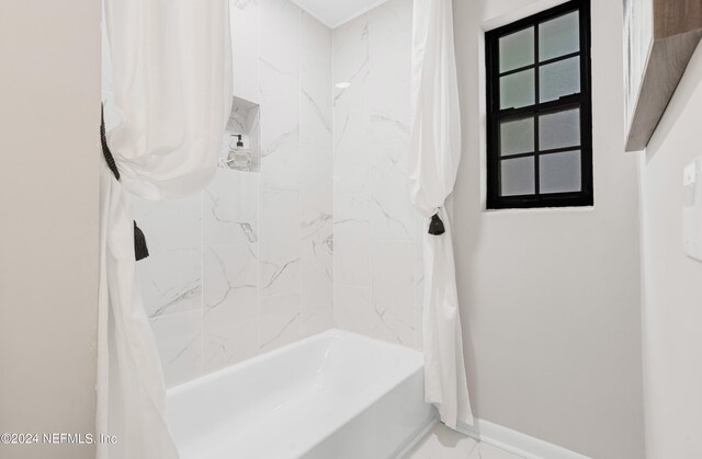 bathroom with shower / tub combo with curtain