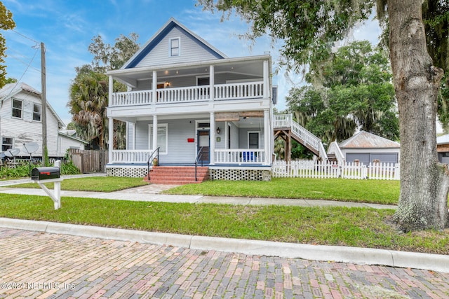 view of front of house with a porch and a front yard