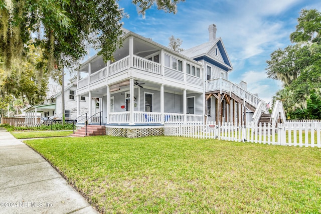 view of front of house featuring a balcony, a porch, and a front yard