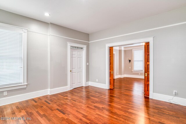 spare room with wood-type flooring