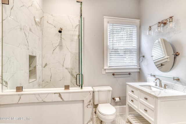 bathroom featuring tile patterned flooring, vanity, toilet, and a shower with shower door