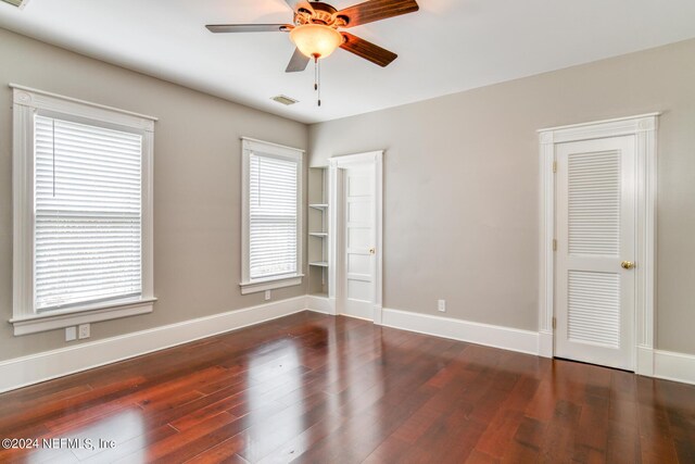 unfurnished room featuring dark hardwood / wood-style flooring and ceiling fan