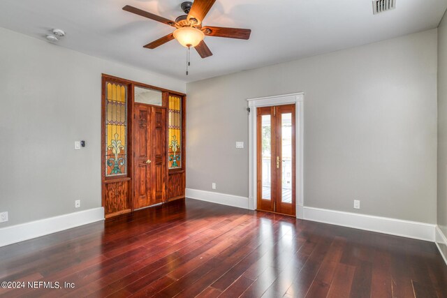 interior space with french doors, ceiling fan, and dark wood-type flooring