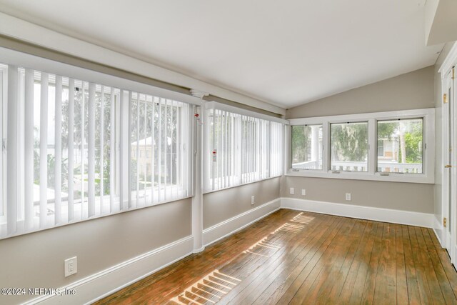 unfurnished sunroom featuring vaulted ceiling