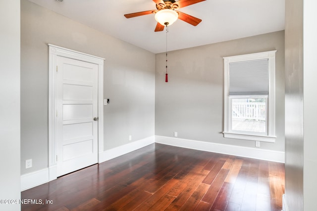 spare room featuring dark hardwood / wood-style flooring and ceiling fan