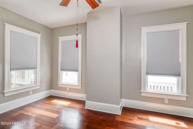 empty room featuring ceiling fan and dark hardwood / wood-style flooring