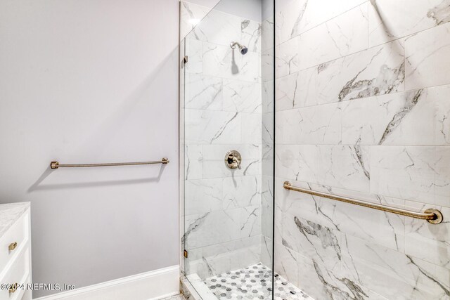 bathroom with vanity and tiled shower