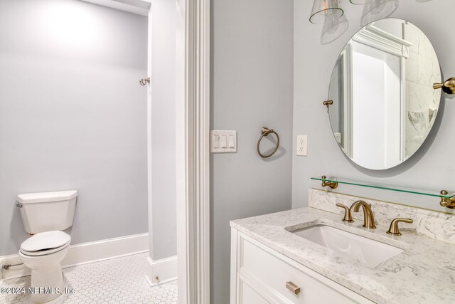 bathroom with tile patterned flooring, vanity, and toilet