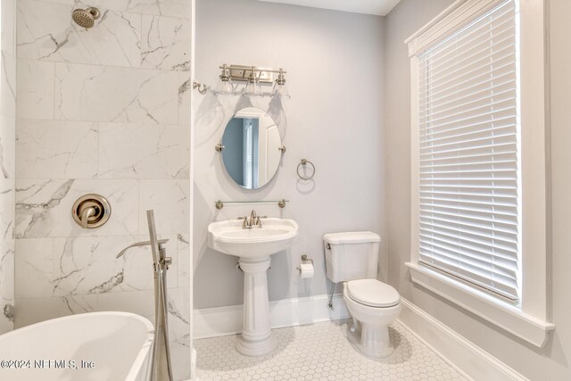 bathroom with a bathing tub, toilet, and tile patterned floors