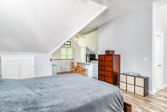 bedroom featuring light hardwood / wood-style flooring and vaulted ceiling