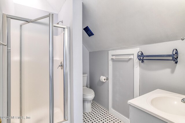 bathroom featuring toilet, vanity, vaulted ceiling, and walk in shower