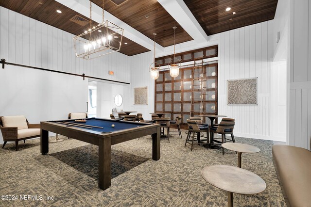 game room featuring a barn door, billiards, a towering ceiling, and wooden ceiling