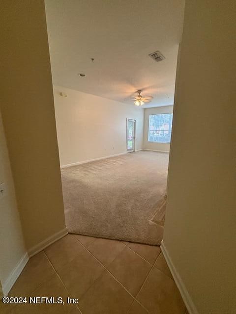 hall with tile patterned flooring