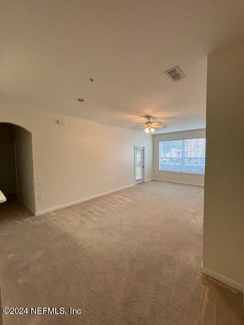 carpeted empty room with ceiling fan