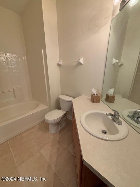 full bathroom featuring tile patterned flooring, vanity, toilet, and shower / bath combination