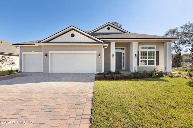 view of front of home with a garage and a front yard