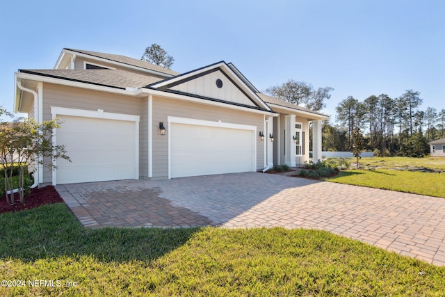 view of front of house with a front yard and a garage