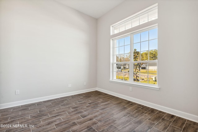 spare room with dark wood-type flooring