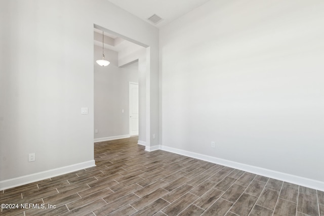 unfurnished room with dark hardwood / wood-style flooring