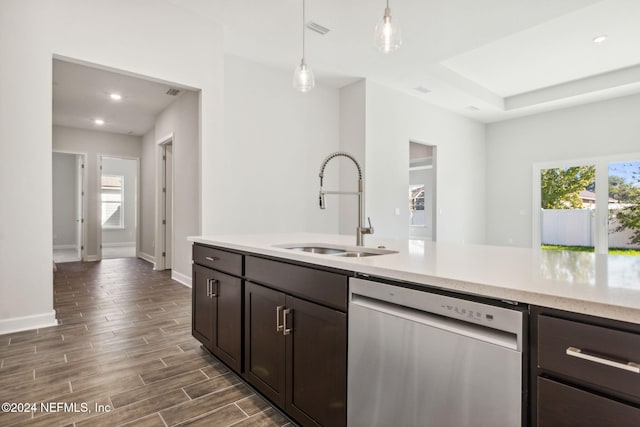 kitchen with sink, hanging light fixtures, stainless steel dishwasher, dark hardwood / wood-style flooring, and dark brown cabinetry