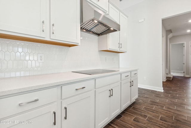 kitchen with backsplash, ventilation hood, black electric cooktop, dark hardwood / wood-style flooring, and white cabinetry