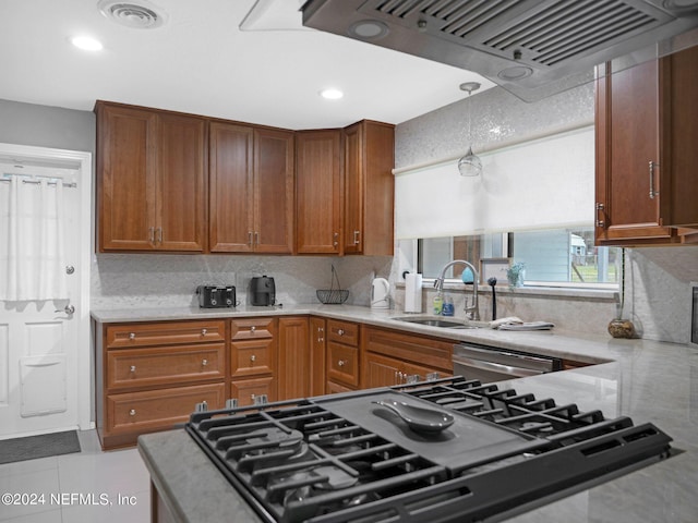 kitchen featuring light tile patterned floors, sink, decorative light fixtures, appliances with stainless steel finishes, and range hood