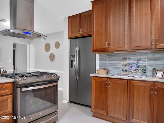 kitchen featuring backsplash, island range hood, light tile patterned flooring, and stainless steel appliances