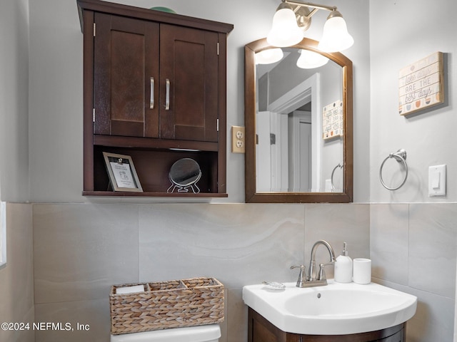 bathroom with tile walls, vanity, and tasteful backsplash