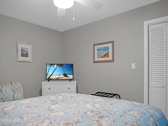 bedroom with ceiling fan and a closet