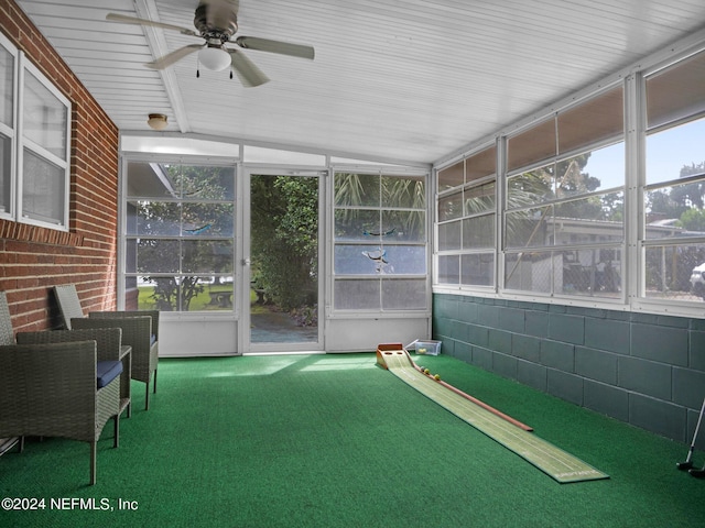 unfurnished sunroom with ceiling fan and vaulted ceiling with beams