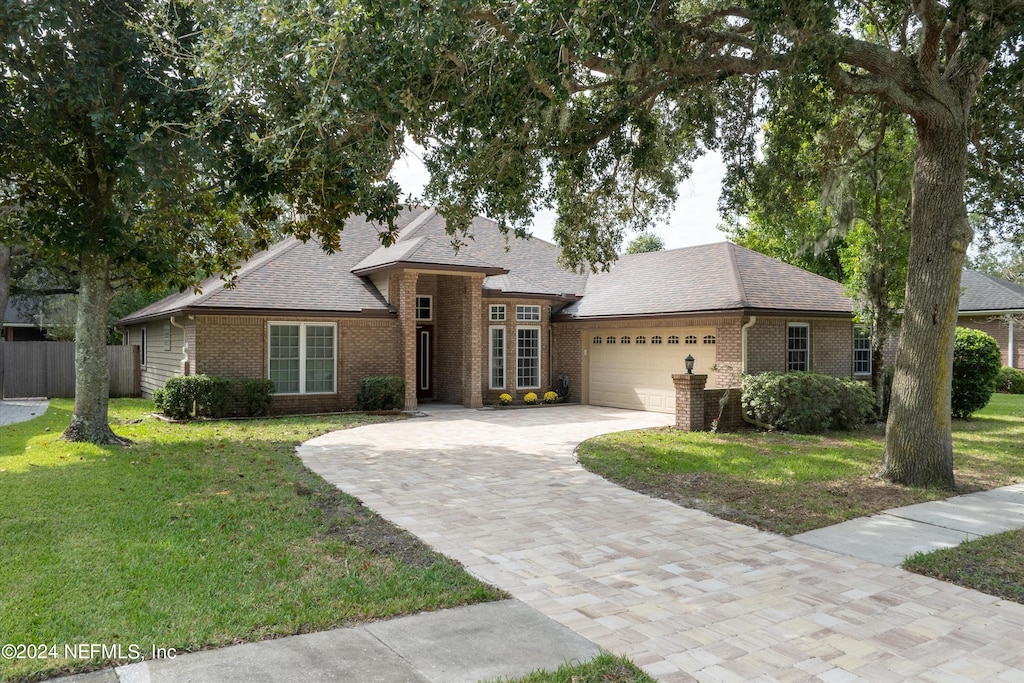 single story home with a front yard and a garage