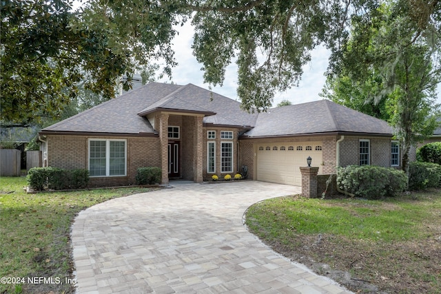 view of front facade with a front lawn and a garage