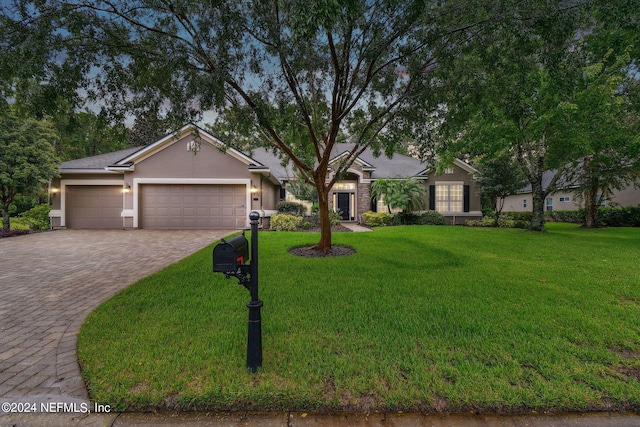 ranch-style home with a front yard and a garage