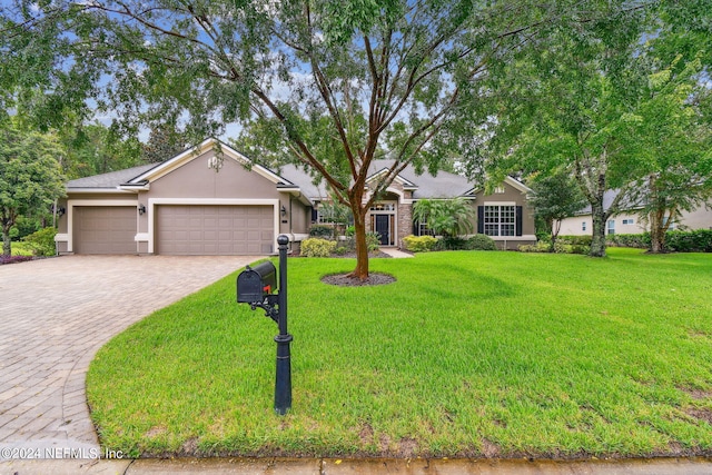 view of front facade featuring a garage and a front yard